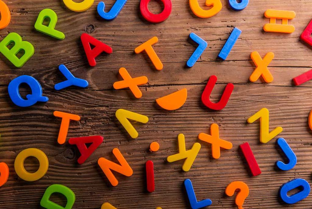 pile of plastic, magnetic letters scattered on tabletop